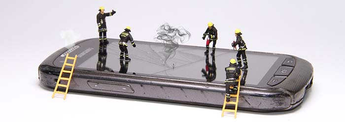 model fireman on top of a mobile phone